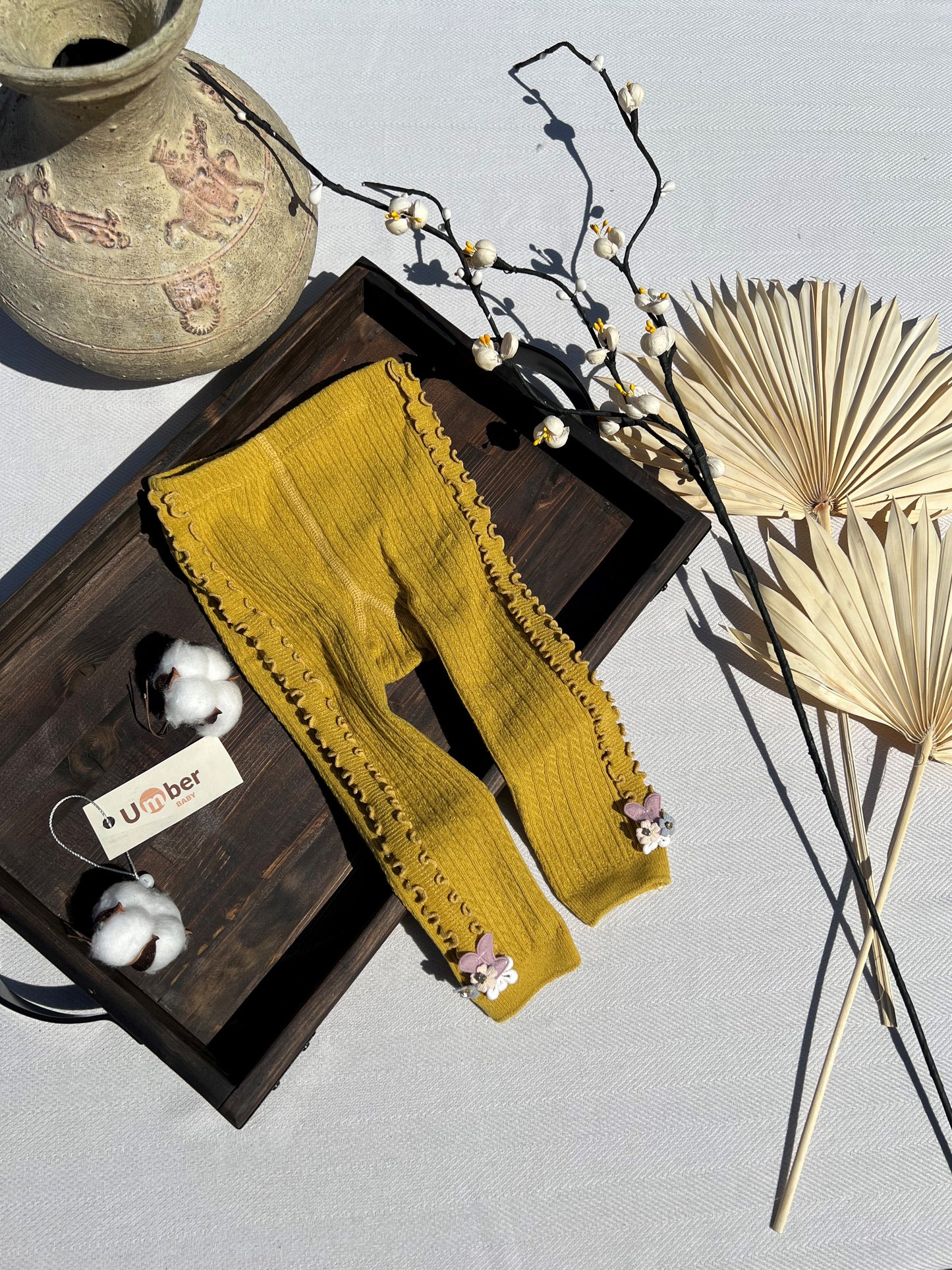 Mustard Side Ruffle Ribbed Baby Tights with a Small 3D Cluster of Flowers at the Bottom of Each Leg