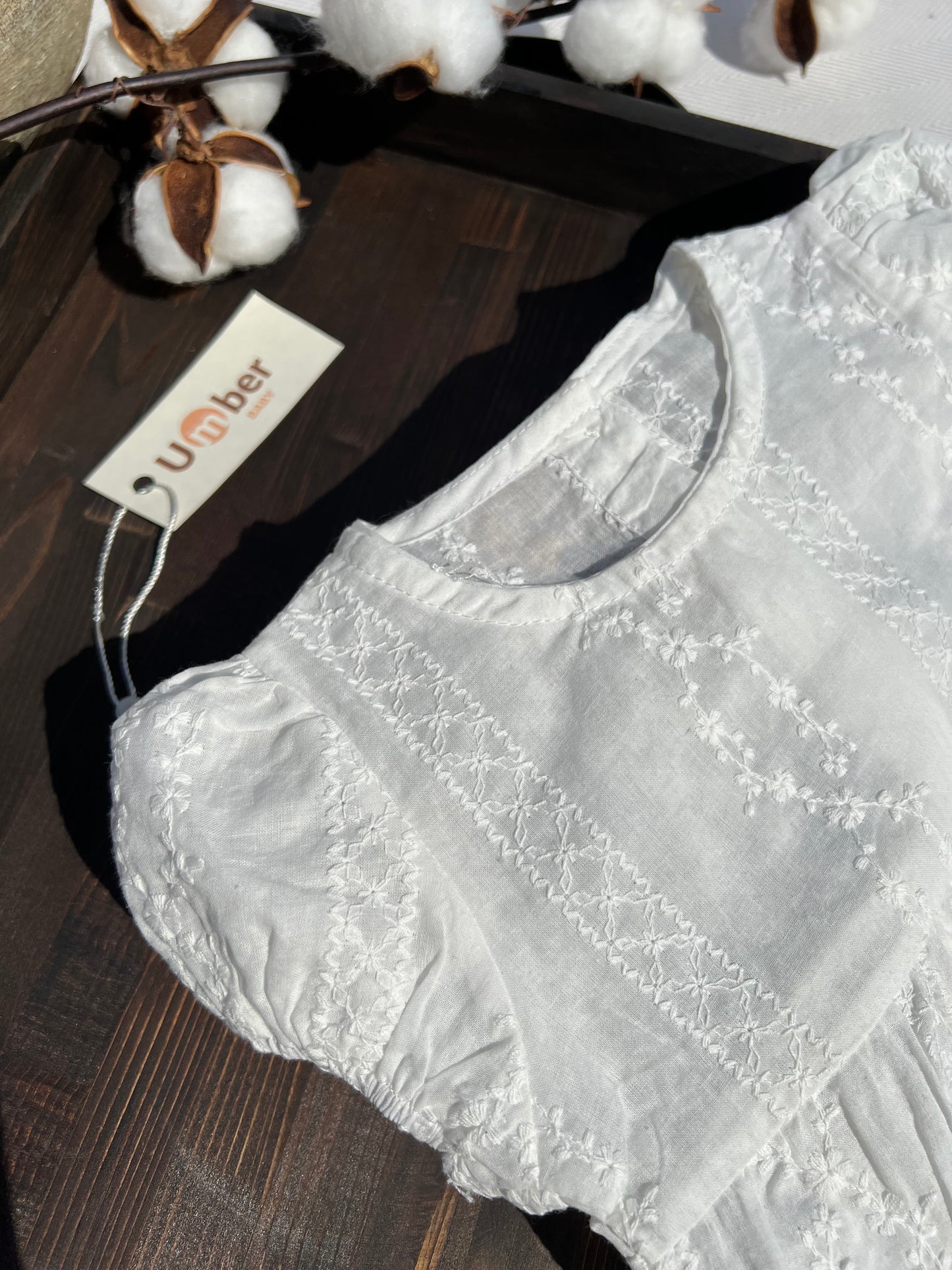 White Baby Romper with Embroidered Flower Pattern