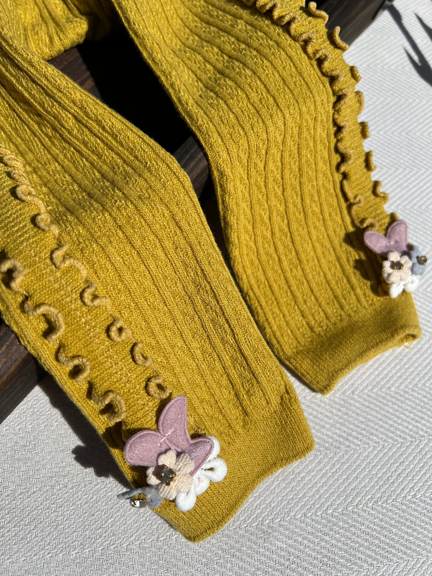 Mustard Side Ruffle Ribbed Baby Tights with a Small 3D Cluster of Flowers at the Bottom of Each Leg