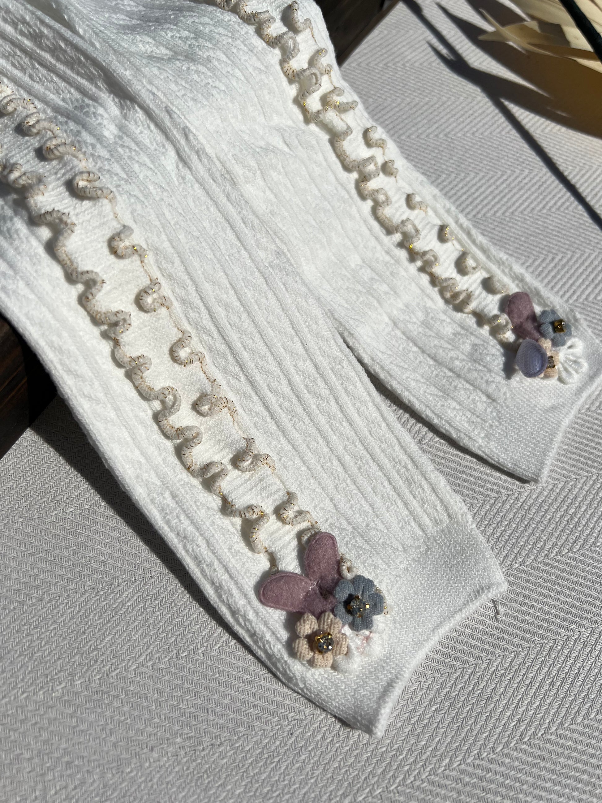 White Side Ruffle Ribbed Baby Tights with a Small 3D Cluster of Flowers at the Bottom of Each Leg